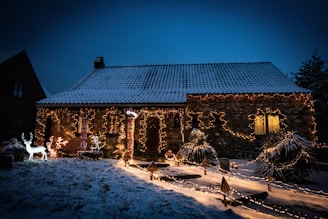 A cozy home adorned with colorful Christmas lights glowing in the evening.