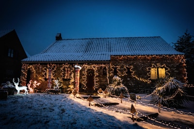 A cozy home adorned with colorful Christmas lights glowing in the evening.