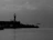 Black-and-white hand-drawn seaside scene with a whimsical boat and lighthouse.