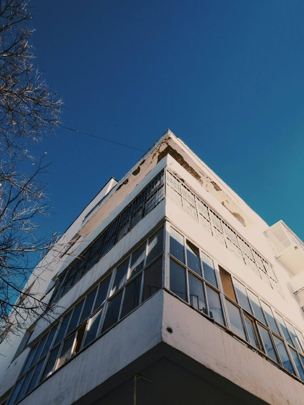 a tall white building with lots of windows