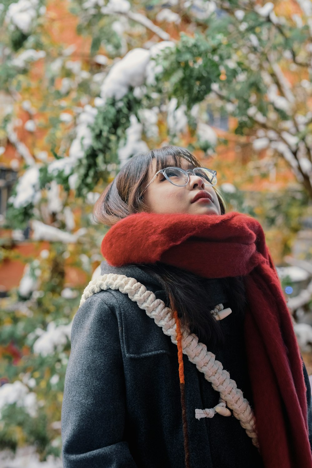 a woman wearing glasses and a red scarf