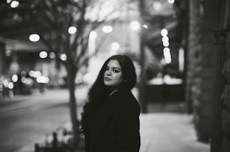 A photographer capturing a candid portrait of a woman in an urban setting.