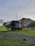 A rugged off-road trailer loaded with Trailgear equipment parked in a scenic mountain campsite at sunset.
