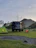 A rugged off-road trailer loaded with Trailgear equipment parked in a scenic mountain campsite at sunset.