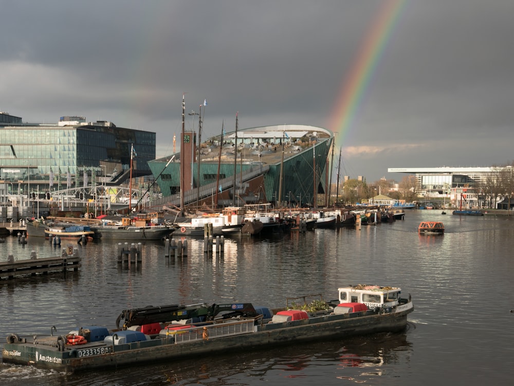 a boat in the water with a rainbow in the background