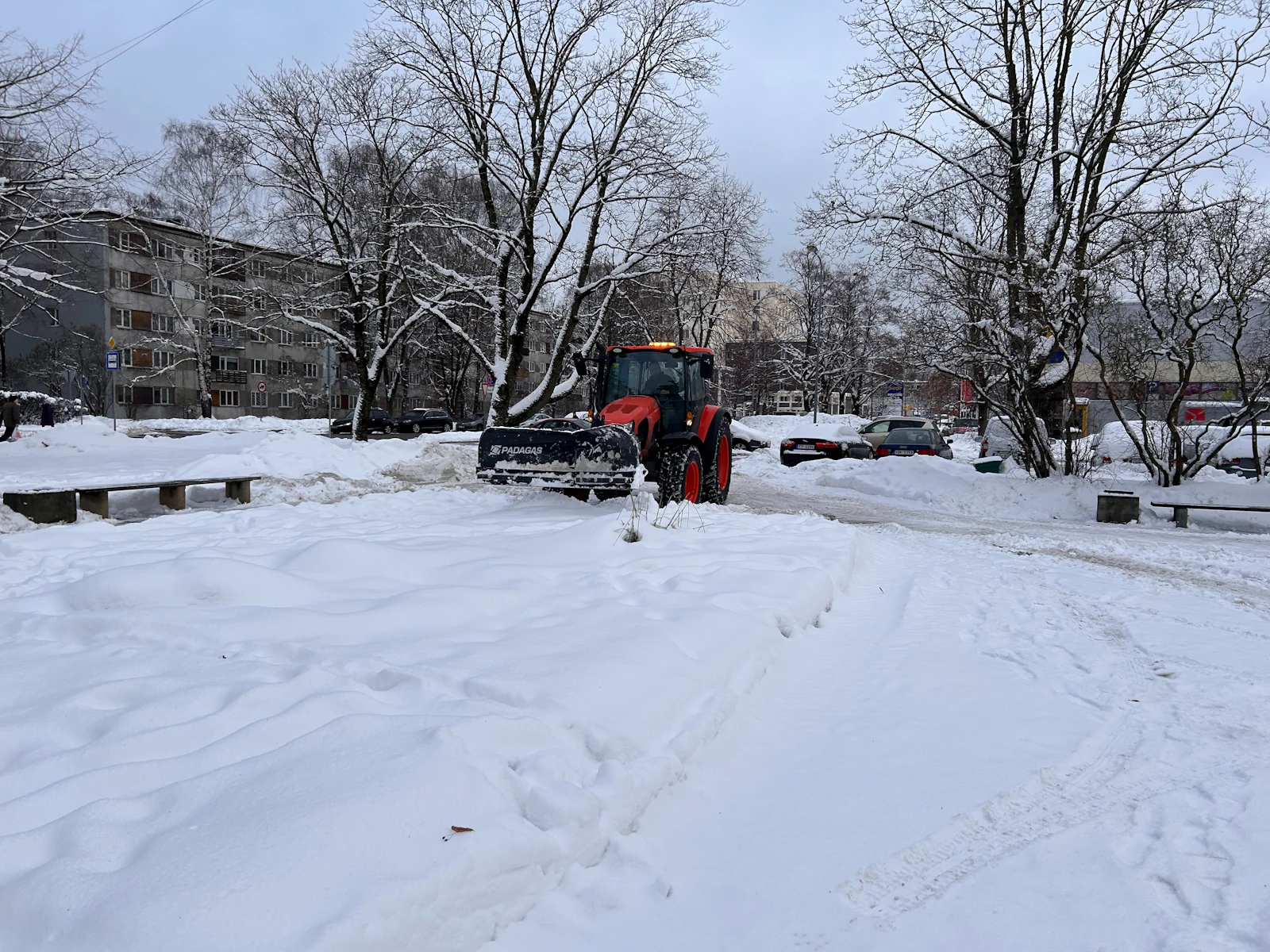 A plow truck on a snow covered street