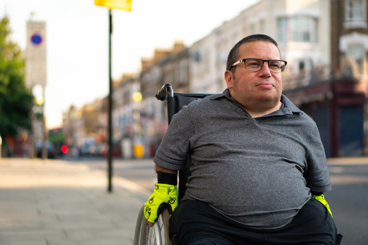 A man in a wheelchair on a city street, representing MedBridge Transport's wheelchair transportation service