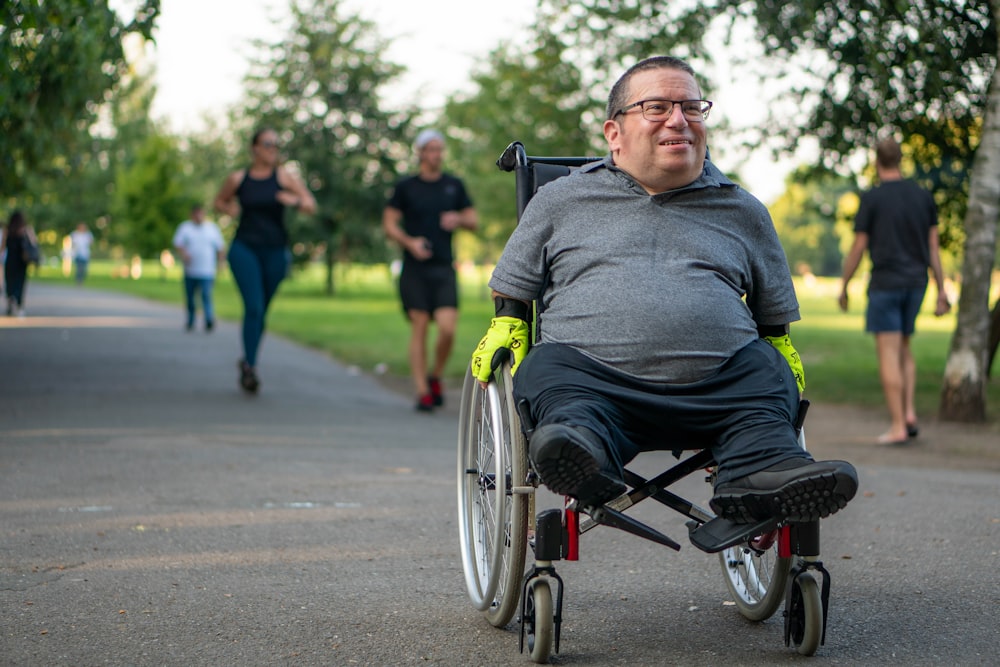 a man in a wheel chair on a path