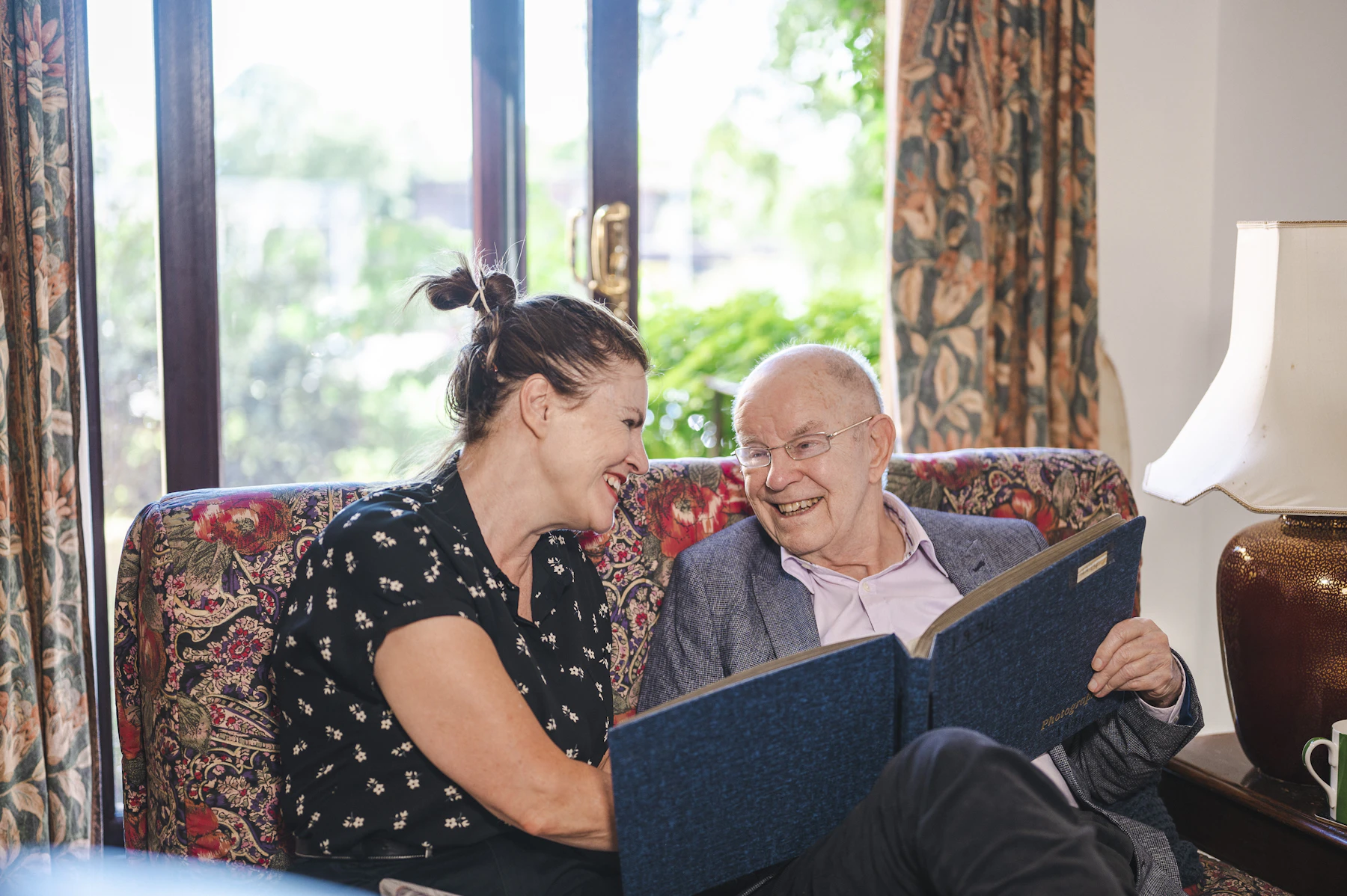 Older man and helper on a sofa