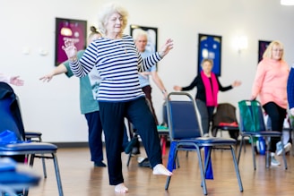 a group of older adults exercising in a room