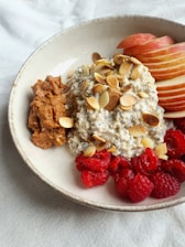 a bowl of oatmeal with fruit and nuts