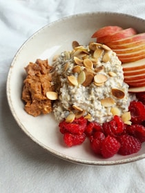 a bowl of oatmeal with fruit and nuts