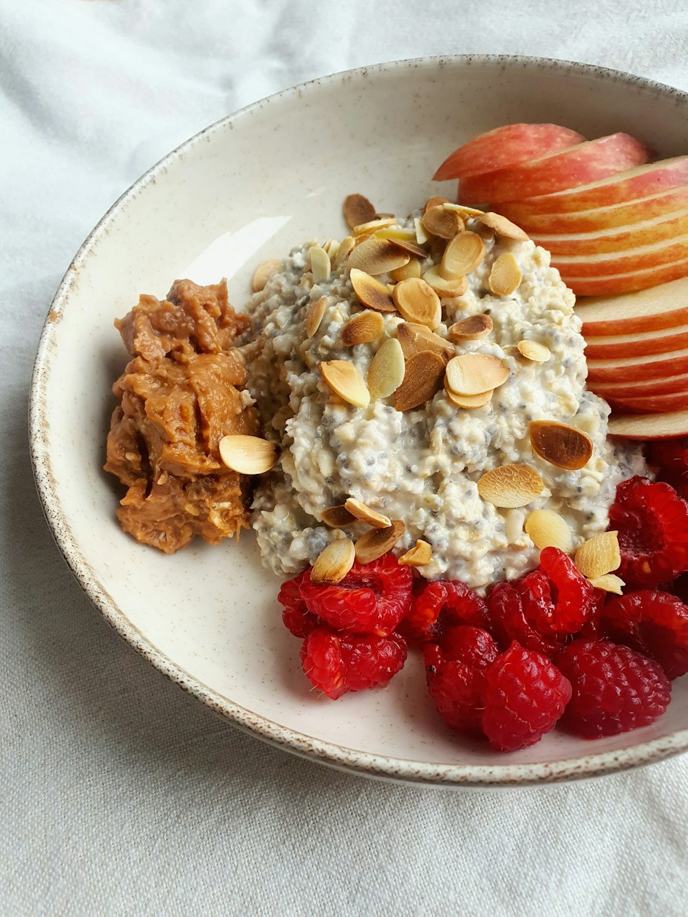 a bowl of oatmeal with fruit and nuts