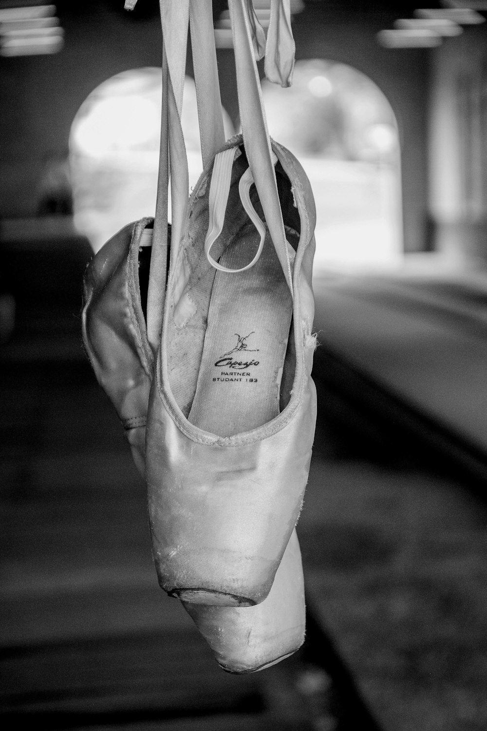 a pair of ballet shoes hanging from a line