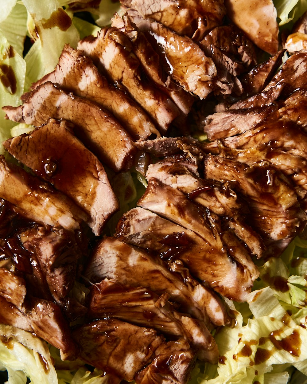 a close up of meat and lettuce on a plate