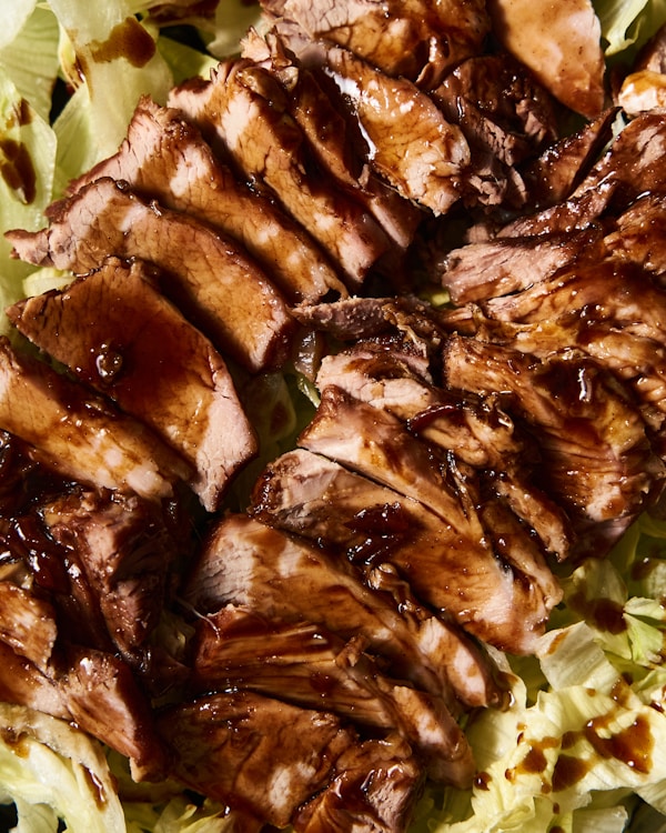 A close up of meat and lettuce on a plate