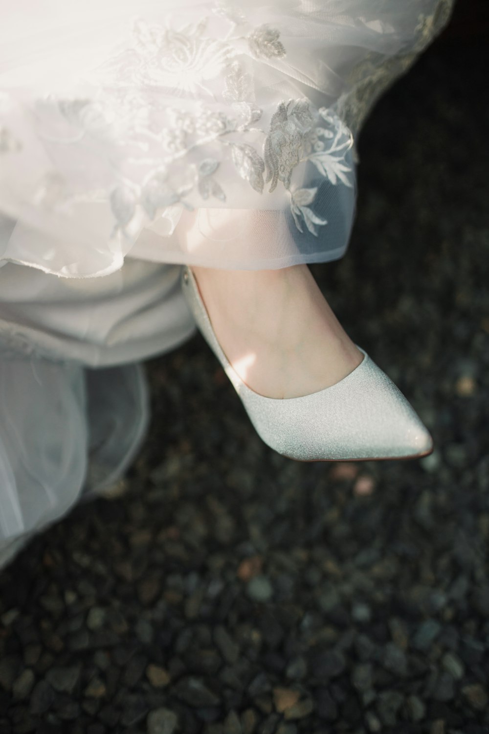 a close up of a bride's wedding shoes