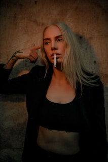 a woman with a cigarette in her mouth