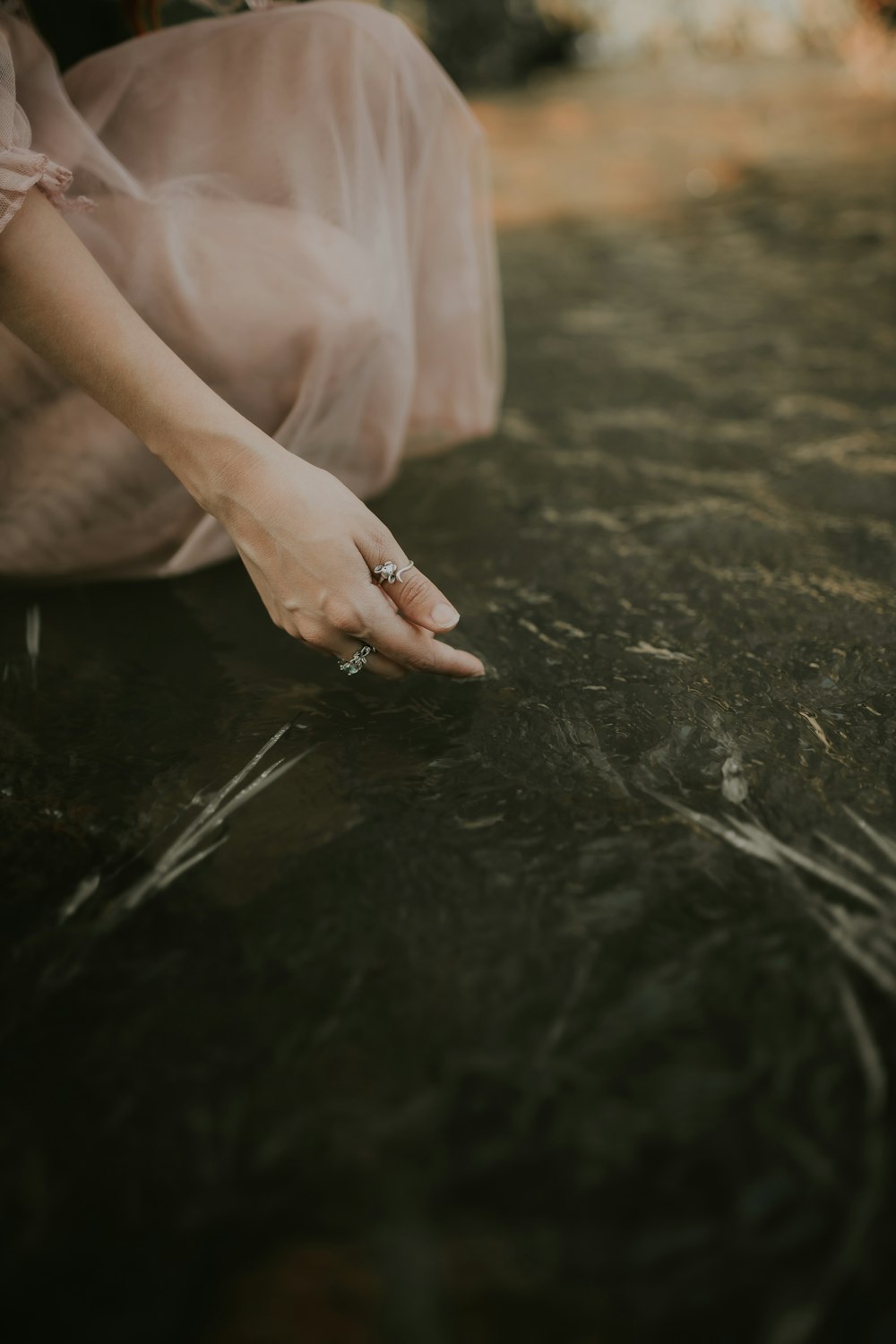 a close up of a person's hand touching the ground