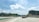 A busy highway with trucks moving swiftly under a bright sky.