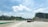 A busy highway with trucks moving swiftly under a bright sky.