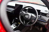 Interior shot showing the modern dashboard and leather seats of a Honda car.