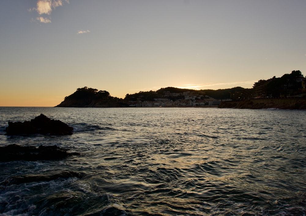 a body of water with a small island in the distance