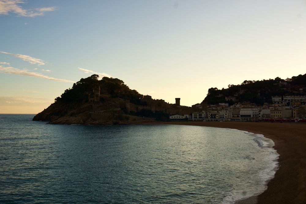 a body of water with a small island in the middle of it