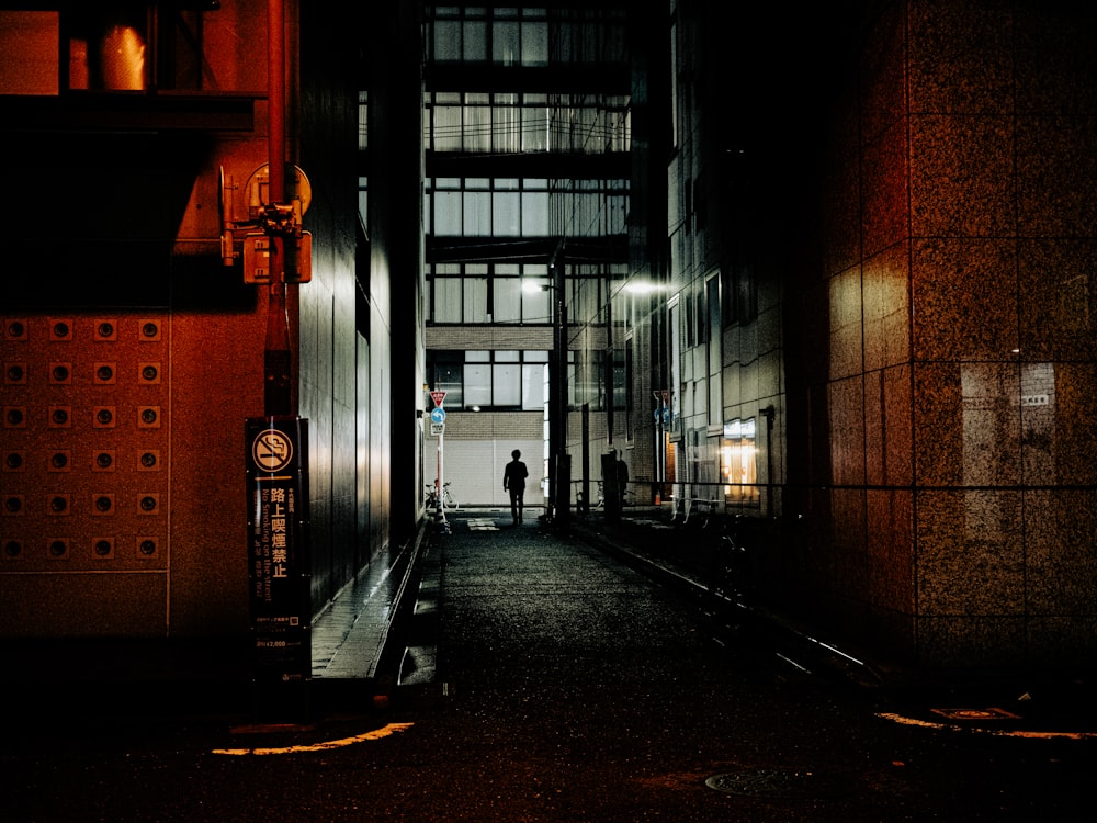 a person standing in a dimly lit hallway