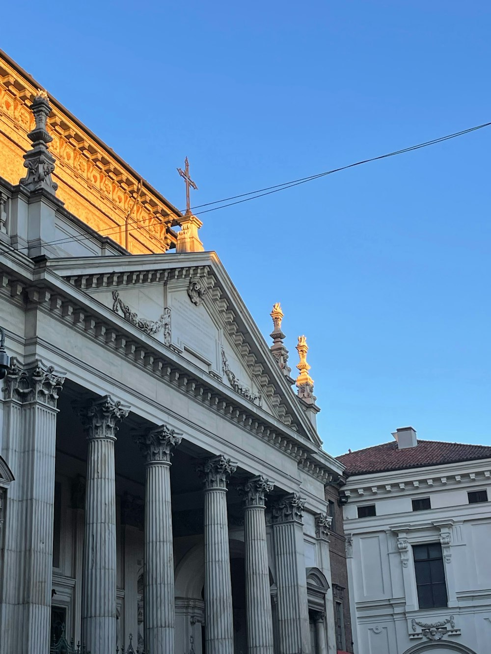 a large building with columns and a clock on the front of it