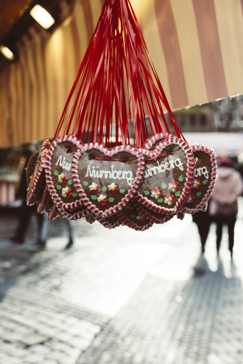 a couple of heart shaped cookies hanging from a string