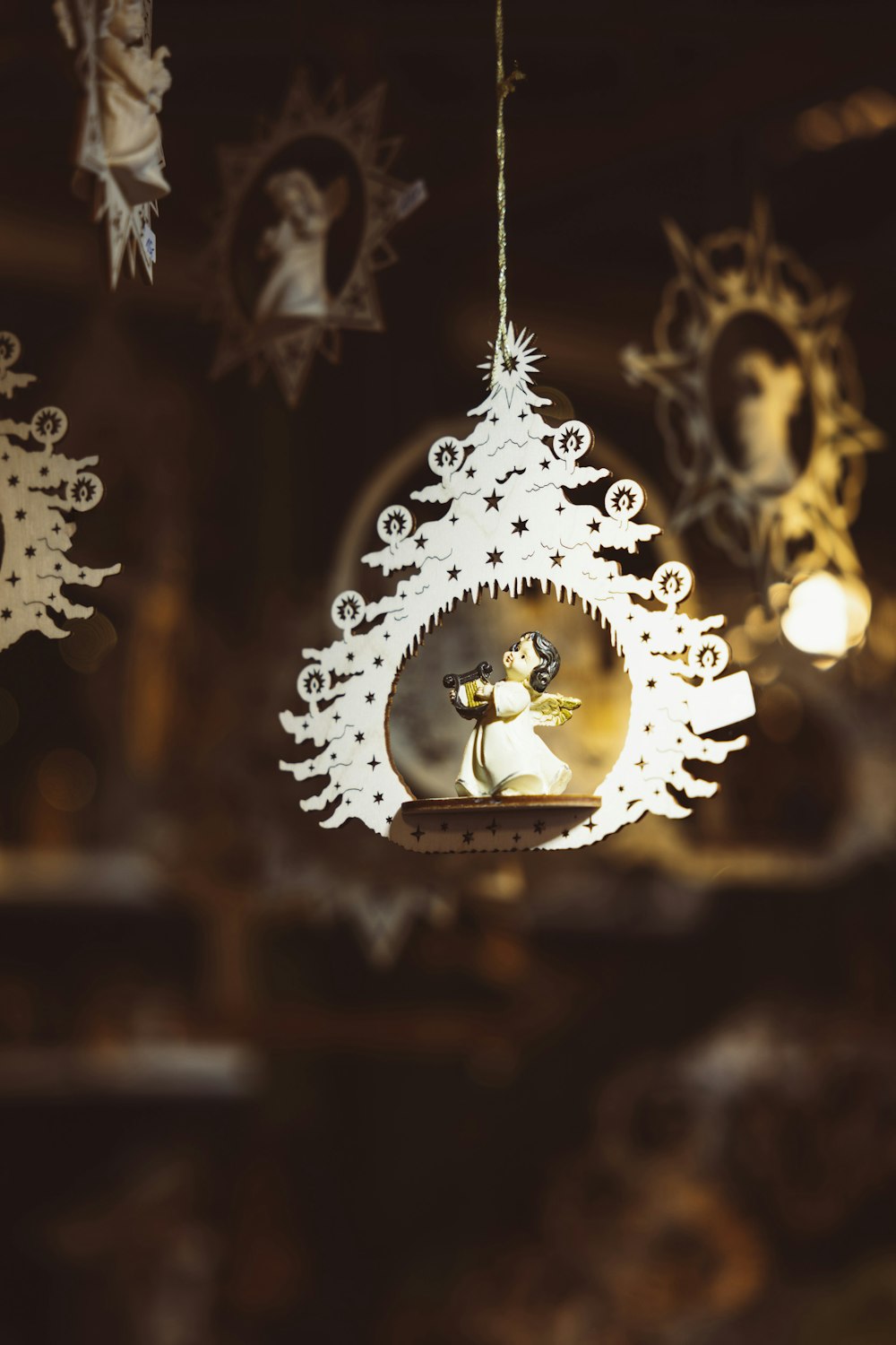 a white christmas ornament hanging from a ceiling