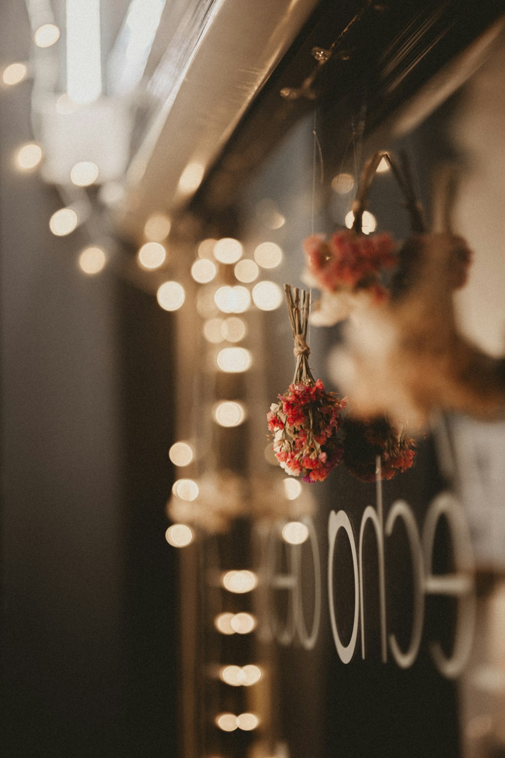 a close up of a sign with lights in the background