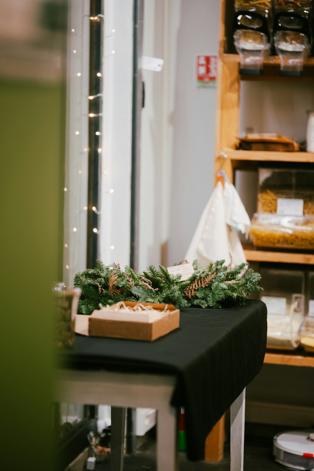 a table topped with a box filled with christmas decorations