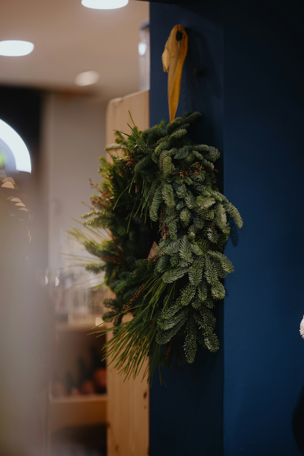 a christmas wreath hanging on a blue wall