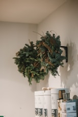a wreath hanging on a wall next to boxes