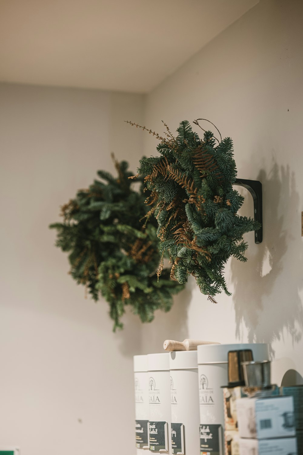 a wreath hanging on a wall next to boxes