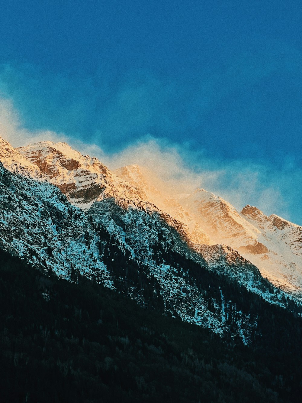 a snow covered mountain with a blue sky in the background