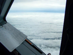 A scenic virtual sky view from inside the flight simulator showing clouds and horizon