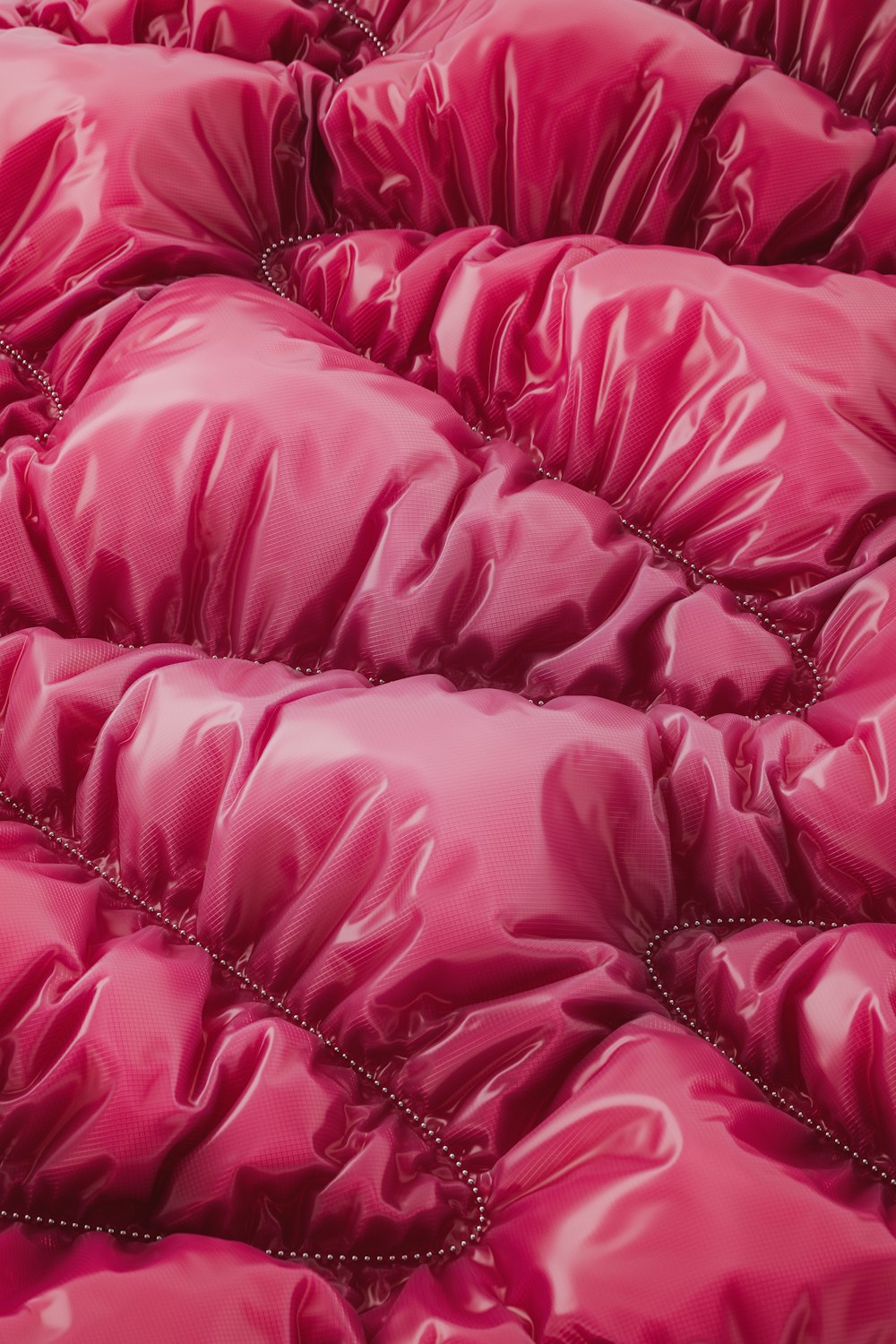 a close up of a pink comforter on a bed