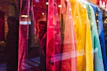 Colorful display of multiple robot-themed t-shirts hanging on a rack