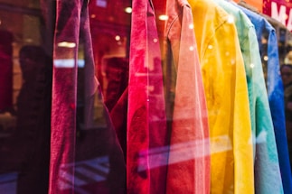 A vibrant streetwear shop with colorful hip hop style t-shirts on display.