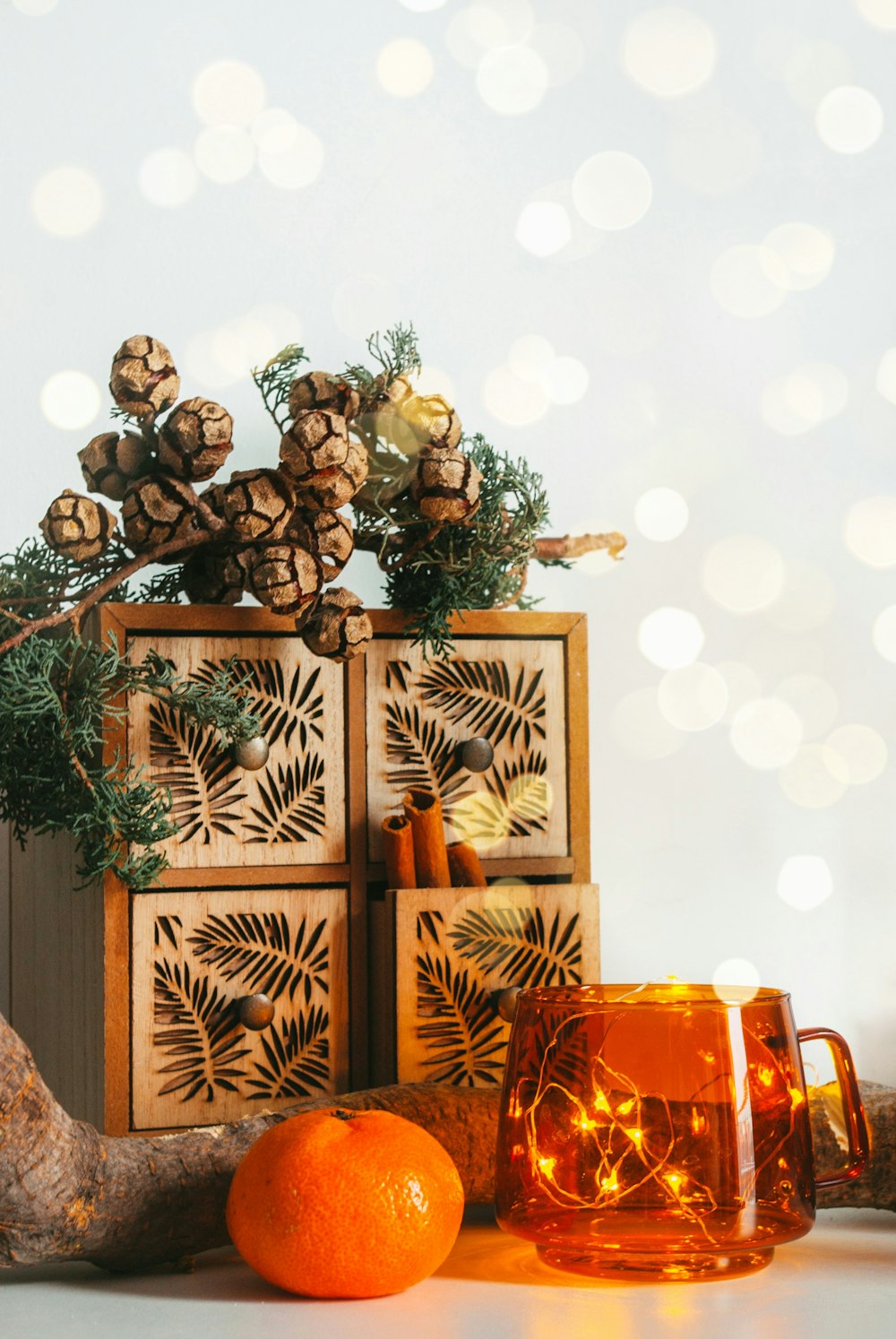 a wooden box with pine cones on top of it