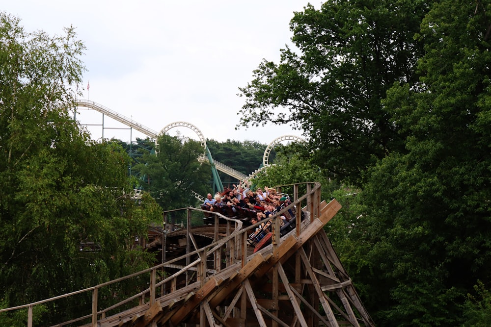 a group of people riding on top of a roller coaster