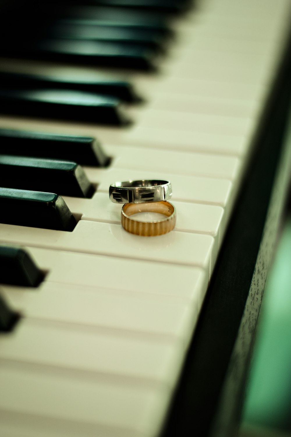 a ring sitting on top of a piano keyboard