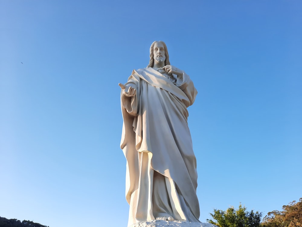 a statue of a woman holding a book