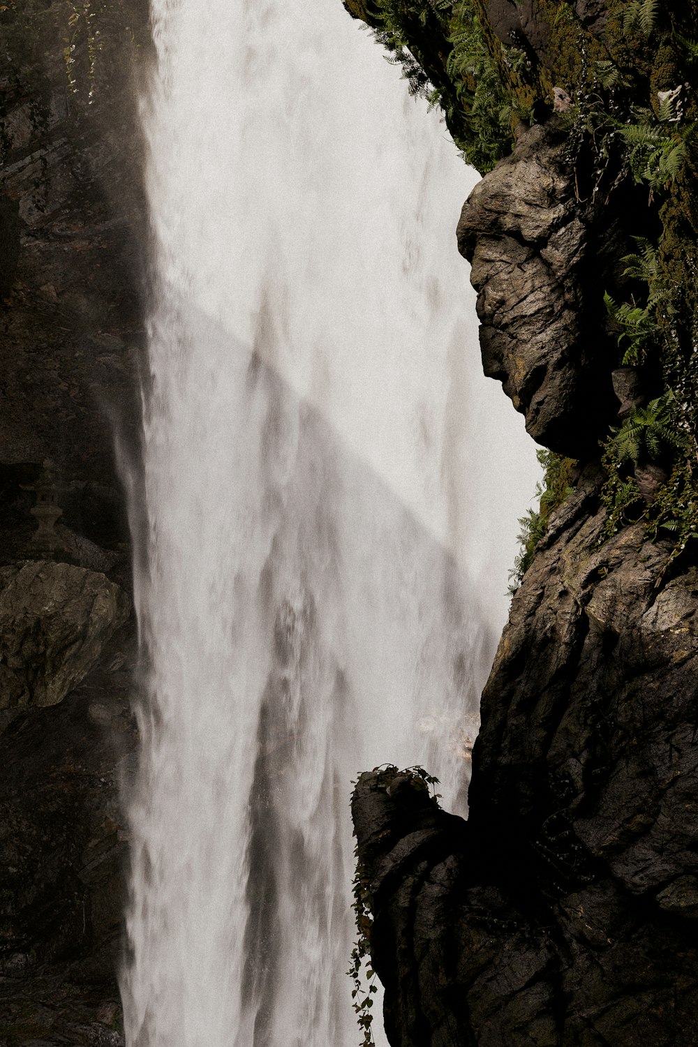 a man standing on the edge of a waterfall