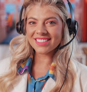 a woman wearing a headset and smiling at the camera