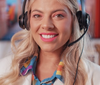 a woman wearing a headset and smiling at the camera