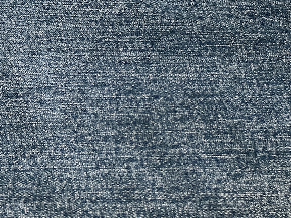 Macro shot of deep blue woven fabric showing fine threads.